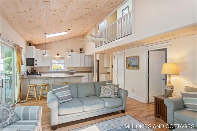 2338 Crescent Walk, Macatawa, MI 49434 - living area featuring light wood-type flooring, plenty of natural light, high vaulted ceiling, wooden ceiling, and baseboards