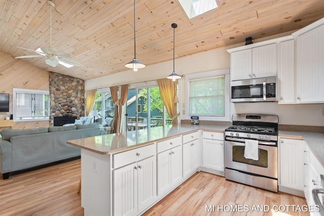 2338 Crescent Walk, Macatawa, MI 49434 - kitchen with stainless steel appliances, wooden ceiling, a skylight, vaulted ceiling, and a peninsula