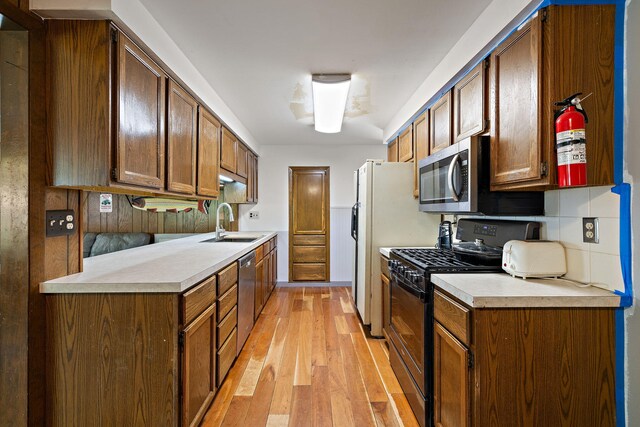 3618 Grape Ave NE, Grand Rapids, MI 49525 - kitchen featuring appliances with stainless steel finishes, a sink, light wood-type flooring, and light countertops