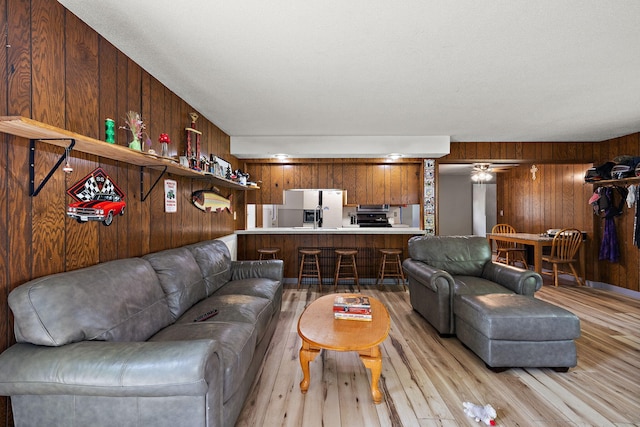 3618 Grape Ave NE, Grand Rapids, MI 49525 - living room featuring light wood-type flooring and wooden walls