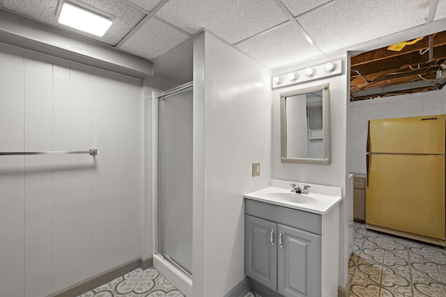 3618 Grape Ave NE, Grand Rapids, MI 49525 - bathroom featuring concrete block wall, a stall shower, vanity, and a drop ceiling