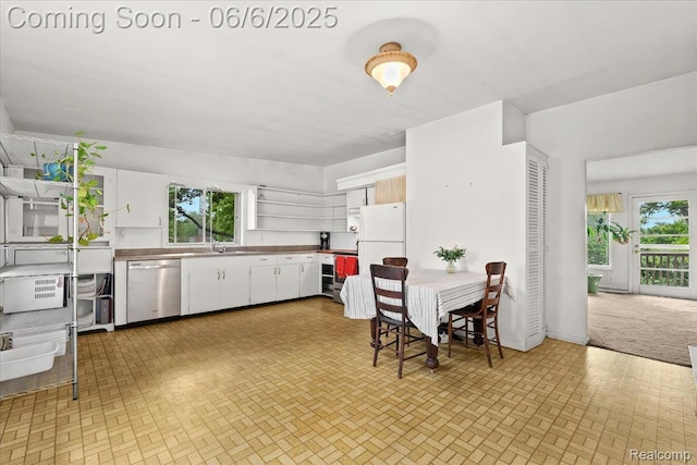 219 Beaver St, Brighton, MI 48116 - kitchen with appliances with stainless steel finishes, open shelves, healthy amount of natural light, and white cabinetry
