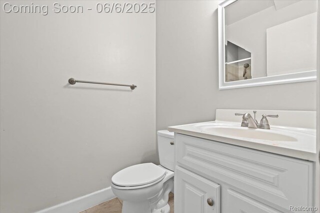 219 Beaver St, Brighton, MI 48116 - bathroom featuring vanity, toilet, baseboards, and tile patterned floors