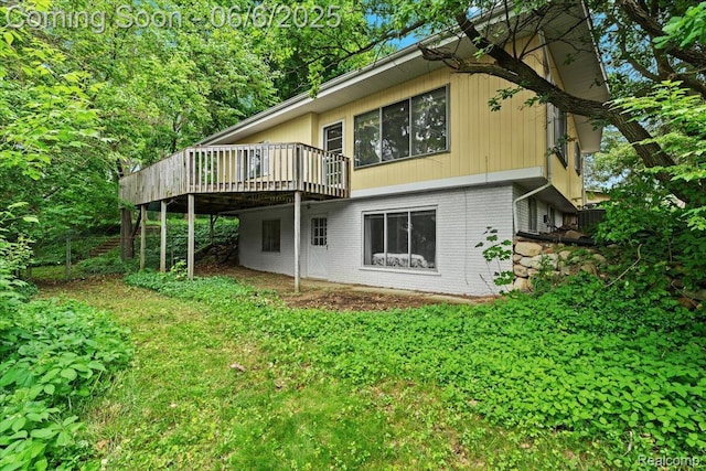 219 Beaver St, Brighton, MI 48116 - back of house featuring brick siding and a wooden deck
