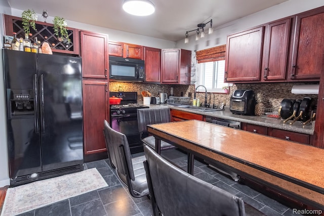 23400 Reynolds Ave, Hazel Park, MI 48030 - kitchen with black appliances, a sink, reddish brown cabinets, and tasteful backsplash
