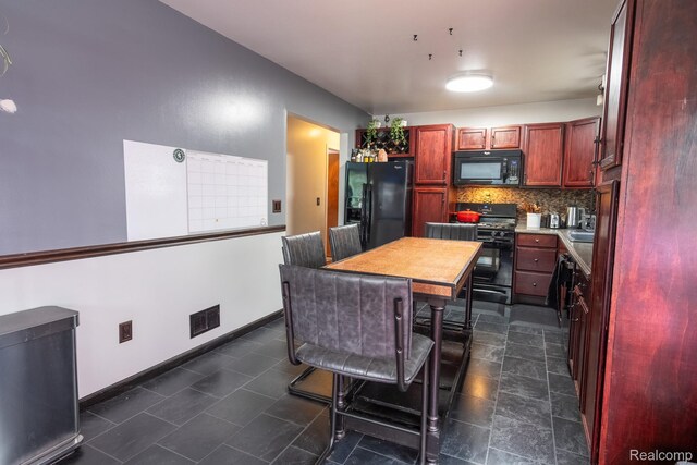 23400 Reynolds Ave, Hazel Park, MI 48030 - kitchen featuring black appliances, reddish brown cabinets, tasteful backsplash, baseboards, and light countertops