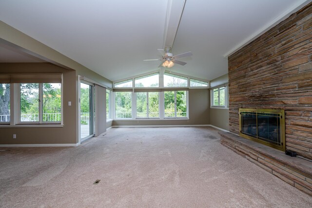 2310 Riverbend Dr, Benton Harbor, MI 49022 - unfurnished living room with baseboards, a ceiling fan, a stone fireplace, carpet floors, and vaulted ceiling