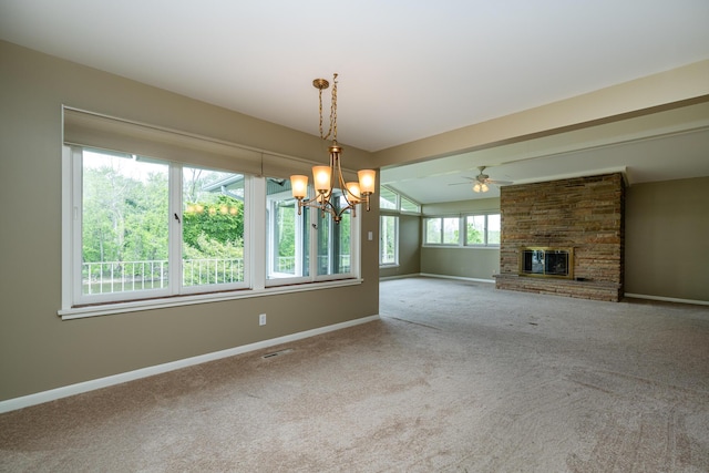 2310 Riverbend Dr, Benton Harbor, MI 49022 - unfurnished living room with carpet flooring, a chandelier, a brick fireplace, baseboards, and a ceiling fan