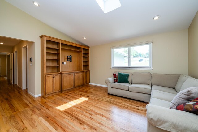 2310 Riverbend Dr, Benton Harbor, MI 49022 - living room with lofted ceiling, light wood-style floors, recessed lighting, baseboards, and a skylight