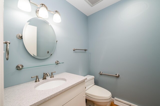 2310 Riverbend Dr, Benton Harbor, MI 49022 - bathroom with toilet, vanity, and a baseboard radiator