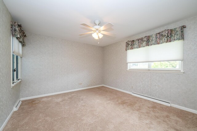 2310 Riverbend Dr, Benton Harbor, MI 49022 - carpeted empty room with a baseboard heating unit and ceiling fan