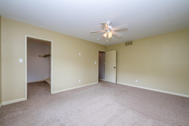 2310 Riverbend Dr, Benton Harbor, MI 49022 - unfurnished bedroom featuring light carpet, baseboards, a spacious closet, and ceiling fan