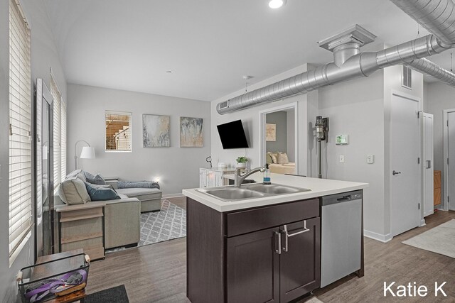 600 Douglas Ave NW Unit 612A, Grand Rapids, MI 49504 - kitchen with stainless steel dishwasher, a sink, open floor plan, light countertops, and wood finished floors
