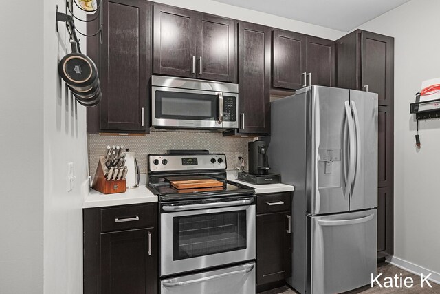 600 Douglas Ave NW Unit 612A, Grand Rapids, MI 49504 - kitchen featuring stainless steel appliances, light countertops, decorative backsplash, and dark brown cabinets