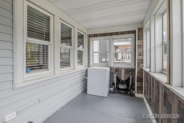 1836 Silver Ave SE, Grand Rapids, MI 49507 - unfurnished sunroom with wooden walls and finished concrete flooring