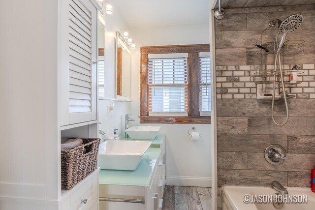 1836 Silver Ave SE, Grand Rapids, MI 49507 - bathroom with double vanity,  shower combination, wood finished floors, and baseboards