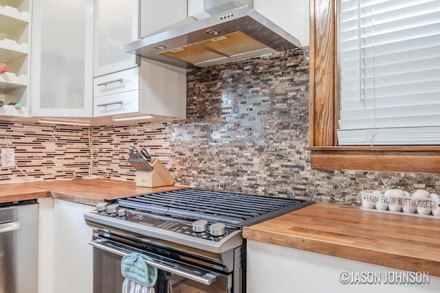 1836 Silver Ave SE, Grand Rapids, MI 49507 - kitchen with stainless steel appliances, butcher block counters, range hood, and white cabinets