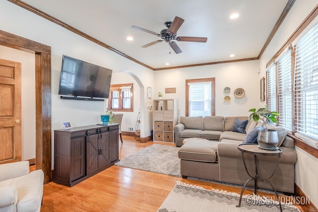 1836 Silver Ave SE, Grand Rapids, MI 49507 - living room featuring light wood-type flooring, plenty of natural light, crown molding, arched walkways, and ceiling fan