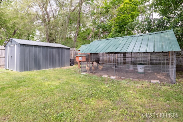 1836 Silver Ave SE, Grand Rapids, MI 49507 - view of yard with an outdoor structure, exterior structure, and view of wooded area
