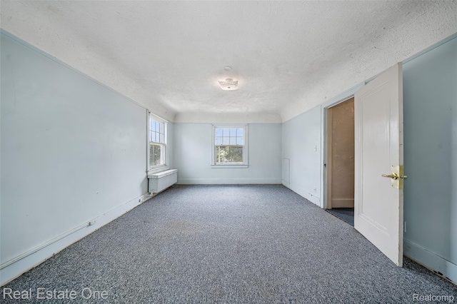 326 W Iroquois Rd, Pontiac, MI 48341 - carpeted empty room with a textured ceiling, radiator, and baseboards