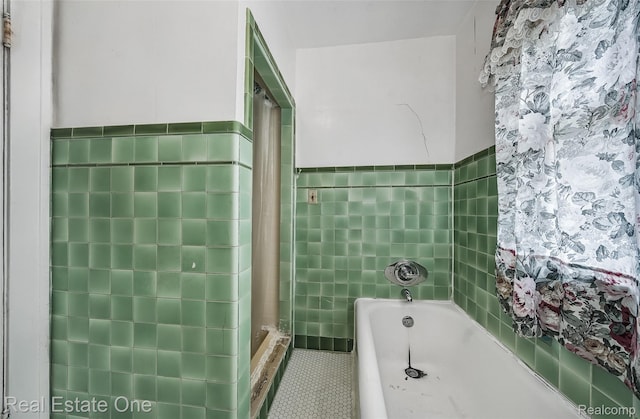 326 W Iroquois Rd, Pontiac, MI 48341 - bathroom featuring tile walls, a bath, tile patterned floors, a wainscoted wall, and a shower