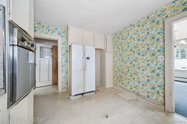 326 W Iroquois Rd, Pontiac, MI 48341 - unfurnished bedroom with white fridge with ice dispenser, wallpapered walls, baseboard heating, and baseboards