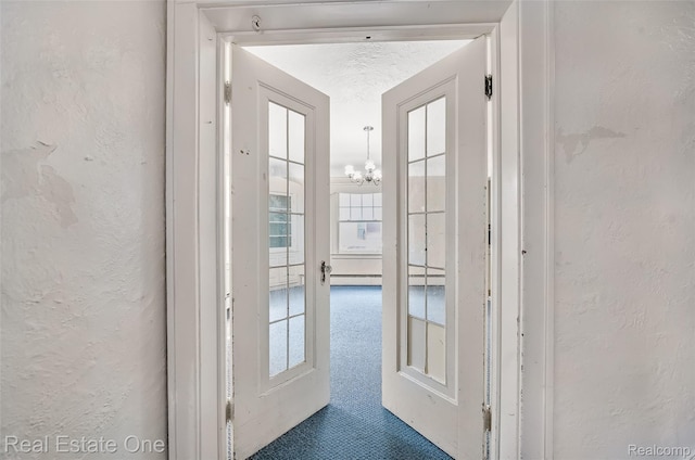 326 W Iroquois Rd, Pontiac, MI 48341 - corridor with a textured wall, a chandelier, and healthy amount of natural light