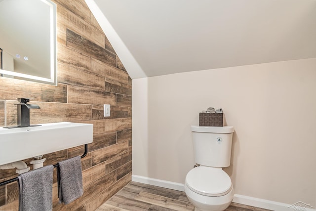 6835 Hackett Rd, Freeland, MI 48623 - bathroom with vaulted ceiling, wood walls, and wood finished floors