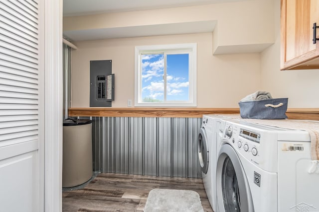 6835 Hackett Rd, Freeland, MI 48623 - washroom with electric panel, washing machine and clothes dryer, wood finished floors, and cabinet space