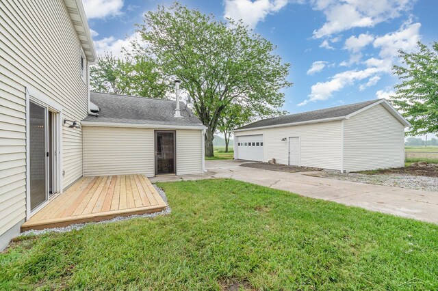 6835 Hackett Rd, Freeland, MI 48623 - view of grassy yard with an outbuilding, a detached garage, and a deck