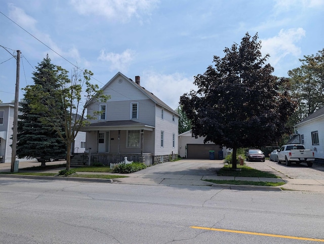 208 State St, Bay City, MI 48706 - view of front of home with a chimney, covered porch, a garage, and an outbuilding