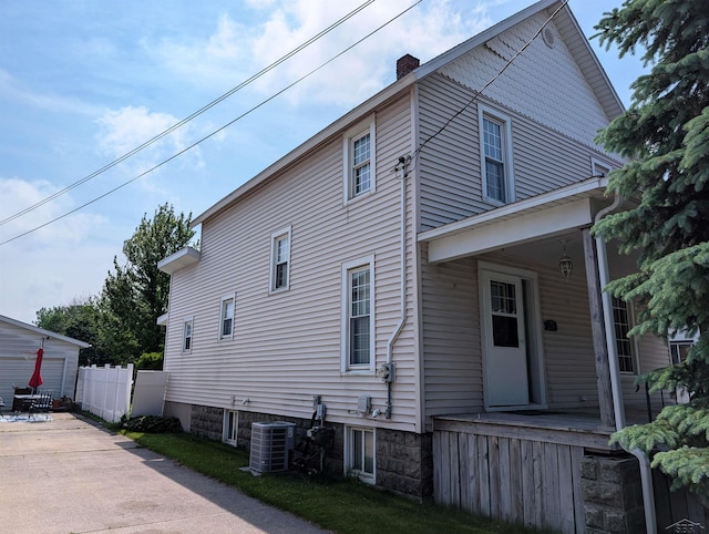 208 State St, Bay City, MI 48706 - view of property exterior featuring central AC and a chimney