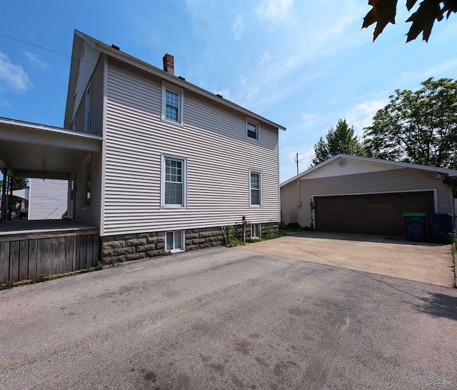 208 State St, Bay City, MI 48706 - view of side of property featuring a chimney, an outbuilding, and a detached garage