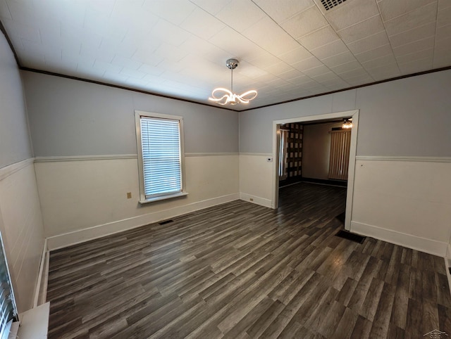 208 State St, Bay City, MI 48706 - unfurnished room with wainscoting, dark wood-style floors, a chandelier, ornamental molding, and baseboards