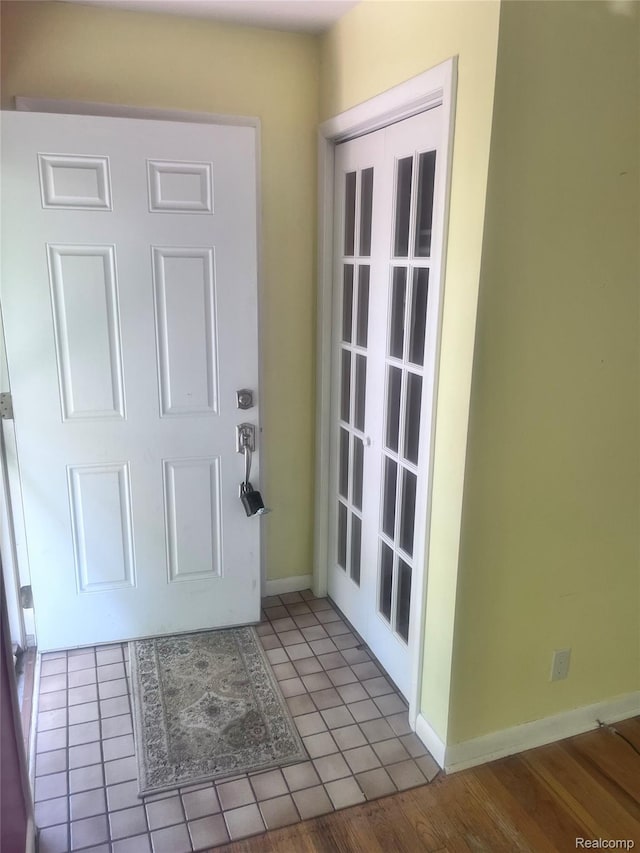 140 Pershing Dr NE, Grand Rapids, MI 49505 - foyer with baseboards and tile patterned flooring