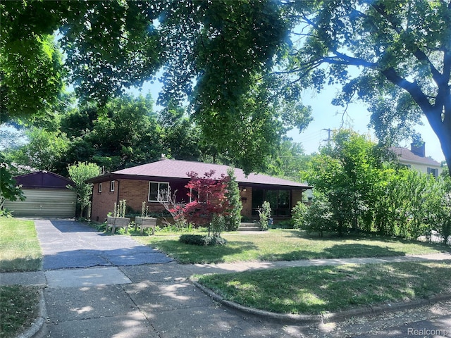 140 Pershing Dr NE, Grand Rapids, MI 49505 - ranch-style home with a front lawn, covered porch, a garage, an outdoor structure, and brick siding