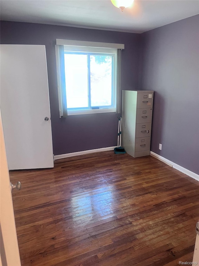 140 Pershing Dr NE, Grand Rapids, MI 49505 - unfurnished bedroom with wood finished floors and baseboards