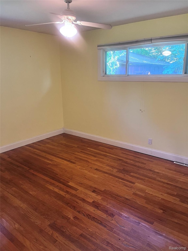 140 Pershing Dr NE, Grand Rapids, MI 49505 - unfurnished room with dark wood-style flooring and ceiling fan