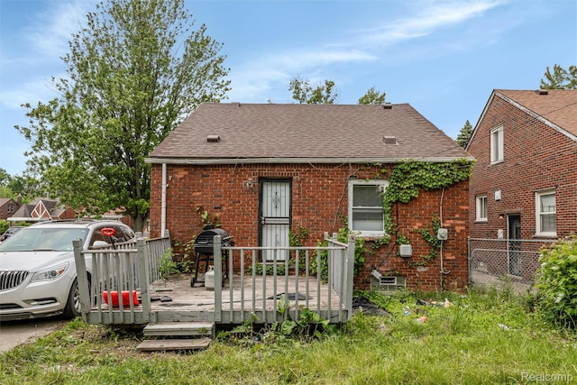 19200 Goulburn St, Detroit, MI 48205 - view of front of house with a deck, brick siding, and roof with shingles