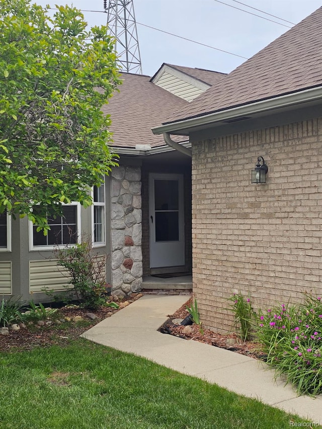 22835 Woodcreek Dr Unit 32, Taylor, MI 48180 - view of exterior entry featuring a shingled roof and stone siding