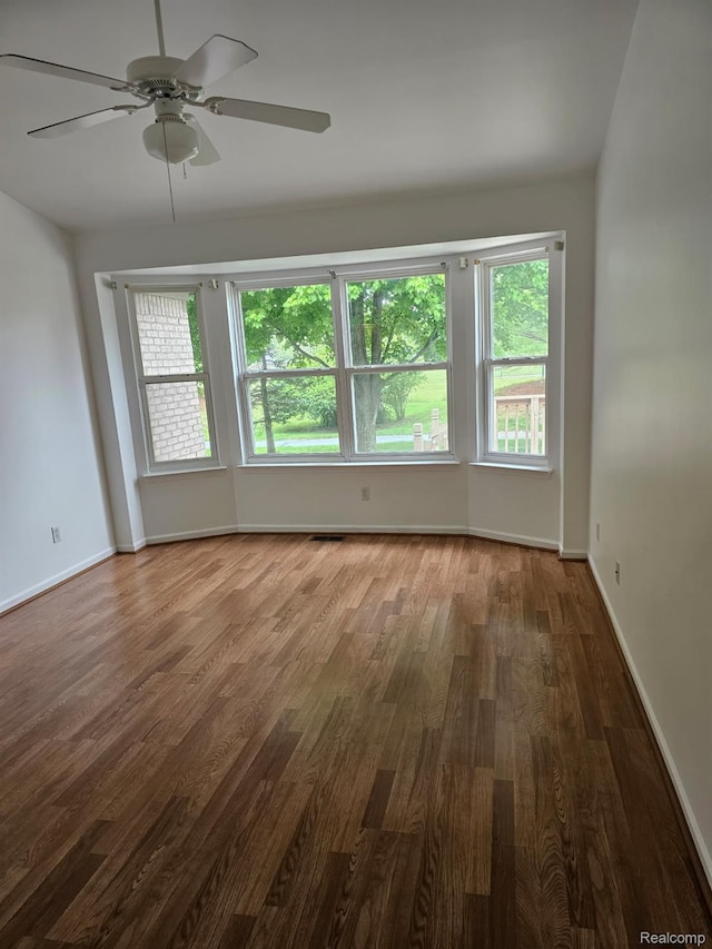 22835 Woodcreek Dr Unit 32, Taylor, MI 48180 - unfurnished room with wood finished floors, healthy amount of natural light, ceiling fan, and baseboards