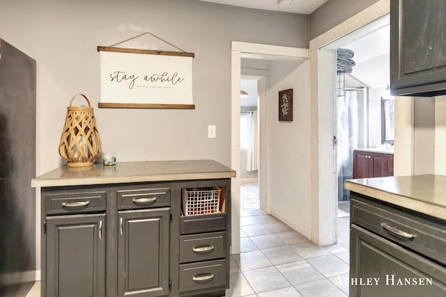 12577 Redmond Ave NE, Cedar Springs, MI 49319 - kitchen with light tile patterned flooring, light countertops, and baseboards