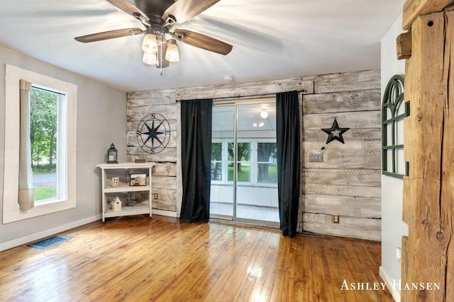 12577 Redmond Ave NE, Cedar Springs, MI 49319 - spare room featuring hardwood / wood-style floors, a ceiling fan, and baseboards