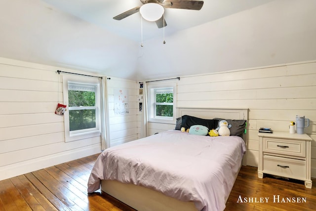 12577 Redmond Ave NE, Cedar Springs, MI 49319 - bedroom featuring dark wood-style flooring, lofted ceiling, wood walls, and a ceiling fan