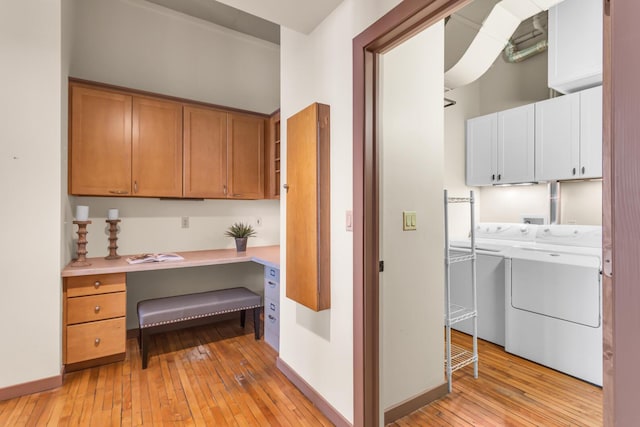 109 W Washington Ave Unit 16, Jackson, MI 49201 - kitchen with light wood-style floors, washer and clothes dryer, light countertops, and baseboards