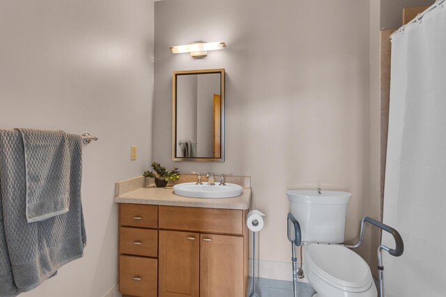 109 W Washington Ave Unit 16, Jackson, MI 49201 - bathroom featuring vanity, toilet, tile patterned floors, baseboards, and a shower with curtain
