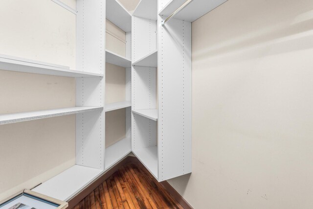 109 W Washington Ave Unit 16, Jackson, MI 49201 - spacious closet featuring dark wood-type flooring