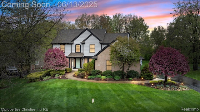 9840 Oak Valley Dr, Clarkston, MI 48348 - view of front of home featuring brick siding and a yard
