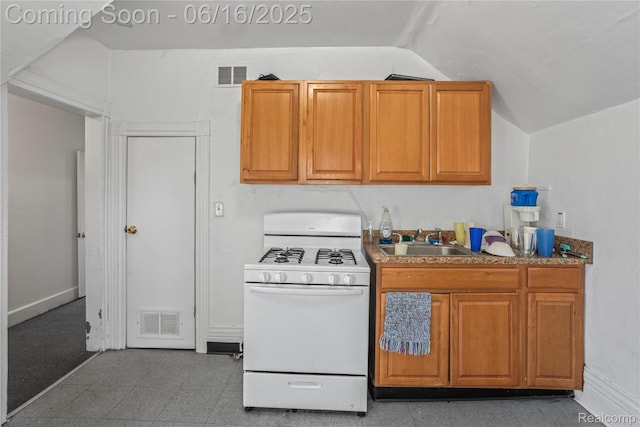 1012 8th St, Port Huron, MI 48060 - kitchen featuring white gas stove, lofted ceiling, and brown cabinetry