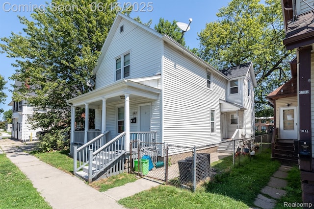 1012 8th St, Port Huron, MI 48060 - traditional style home featuring covered porch, a fenced front yard, and a gate